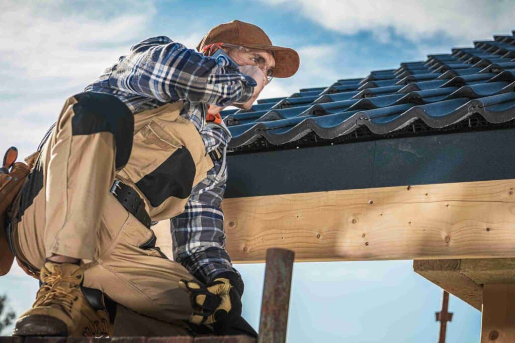 Roof Contractor Talking On Cell Phone.