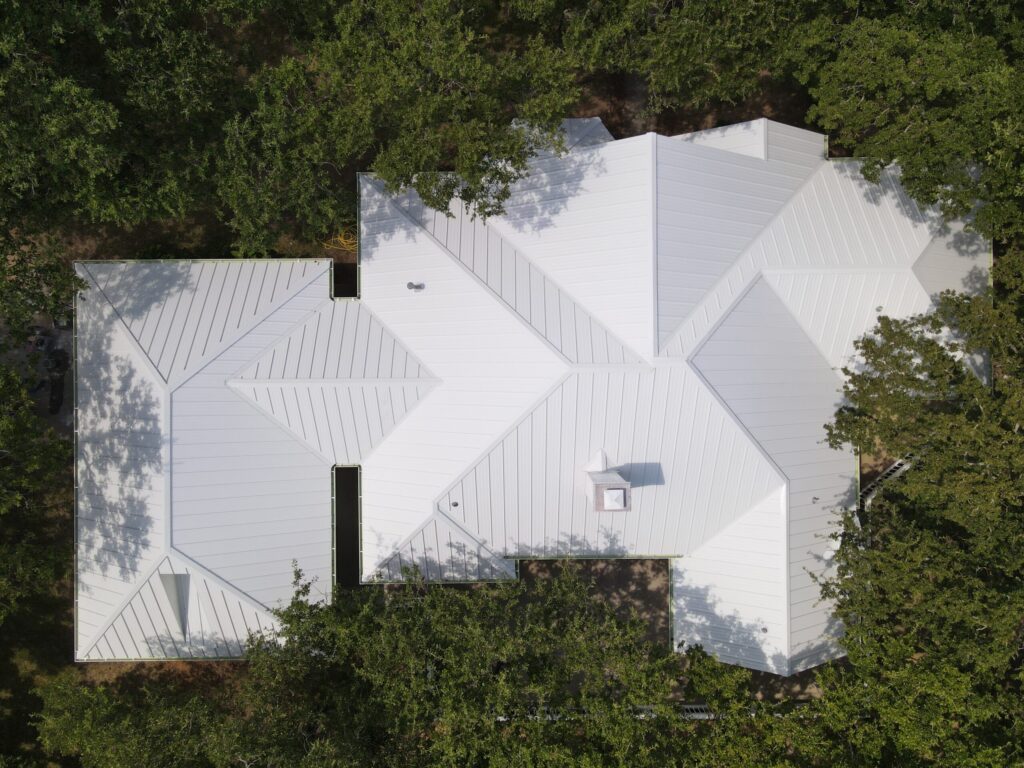 Completed white metal roofing job for homeowner